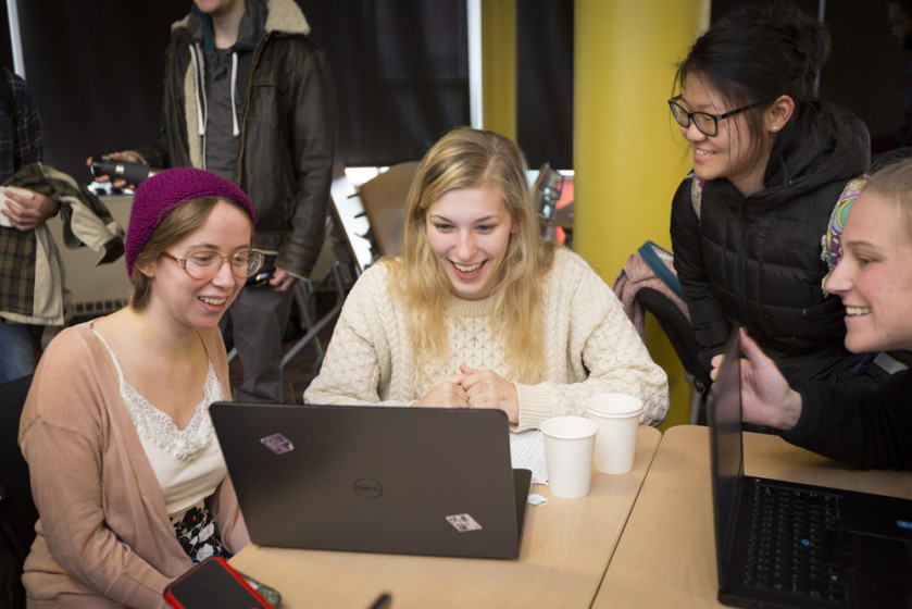 A group of students looking at a computer