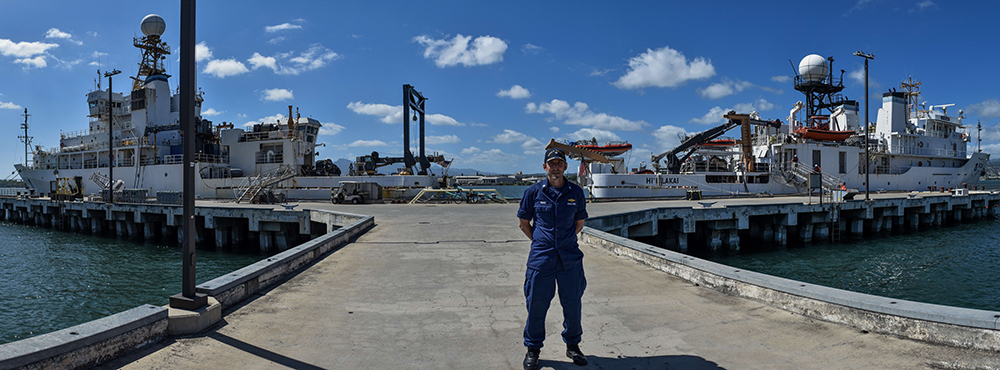 Dan Simon '97 with ships in back