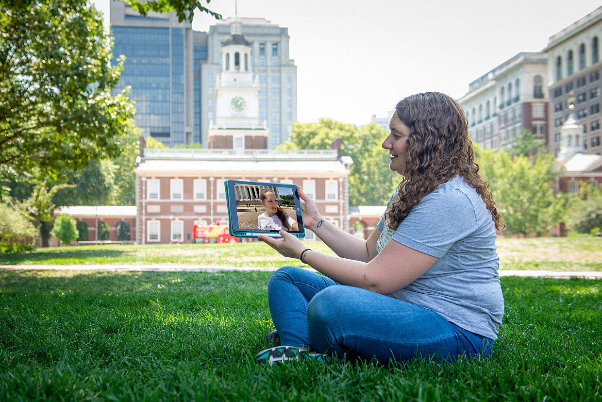 Emily Black (seated) chats with co-podcaster Aubrey Paris on the tablet.