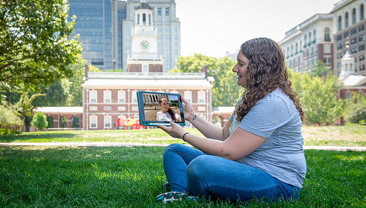 Emily Black (seated) chats with co-podcaster Aubrey Paris on the tablet.