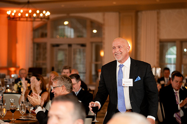 Bear2Bear Benefit and Bash male attendee standing and smiling.