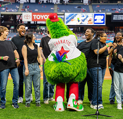 The Philly Phanatic interacts with Voices of Ursinus before singing National Anthem  at the Phillies 2024