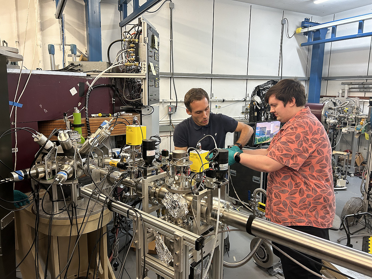 Ursinus student Ewan Chattin (right) installs lead shielding on equipment at Florida State University with Dr. Mark Sieker, a research co...