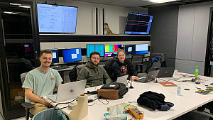 Mill Heinze '24, Jay Kosa '25, and Alyssa Himmelreich '26 at Michigan State University in the user area monitoring detectors and data dur...