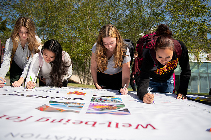 Students, faculty, and staff ceremoniously signed a banner signifying their own wellness commitment at the inauguration luncheon on Octob...