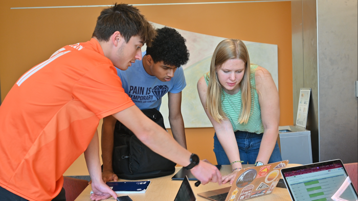 Charles Ohanian, Nihal Kumar, and Margaret Cathcart work on a mathematical biology project as part of the REU program.