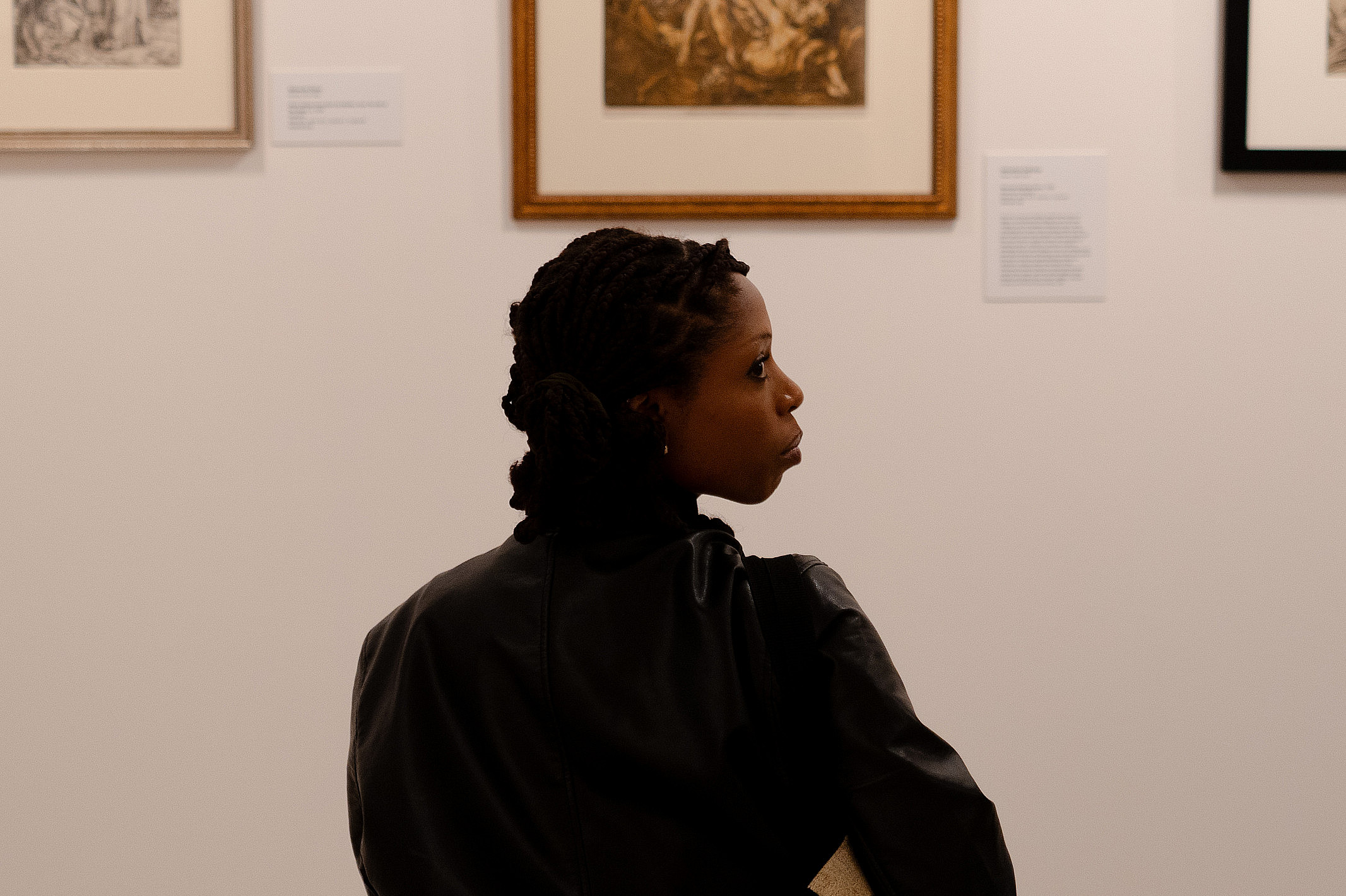 Ursinus student observing the art in Printmaking | Worldmaking.