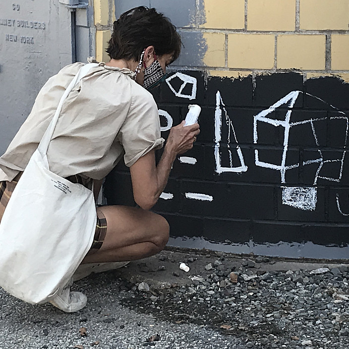 Katie Merz begins drawing at the bottom of the smokestack