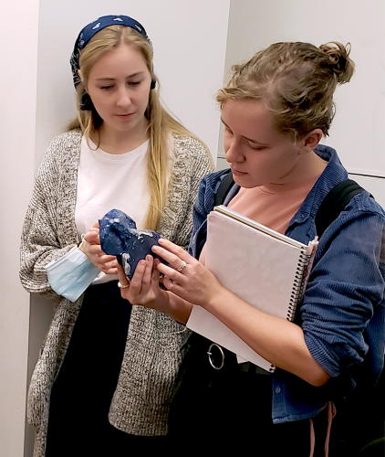 Two museum studies students admiring Dika's recent piece.