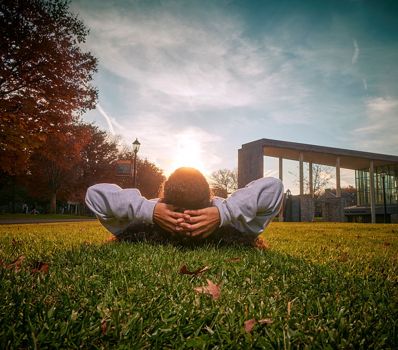 Ursinus student on grass, open campus