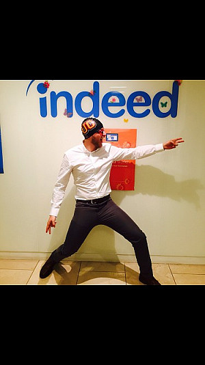 James Marrone posing in front of an Indeed logo