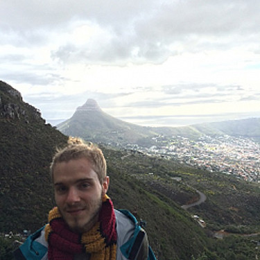 Max Bicking standing in front of a mountain range