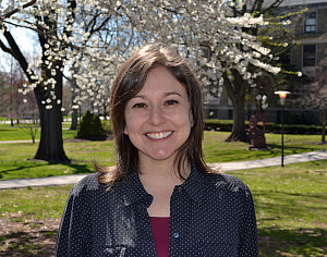 Leah Joseph standing in front of a blossoming tree