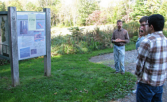 Examining the interpretive signage at the trailhead.