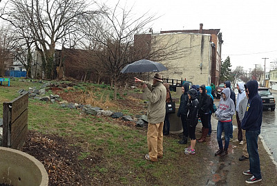 Students tour vacant lot greening projects in West Philadelphia.