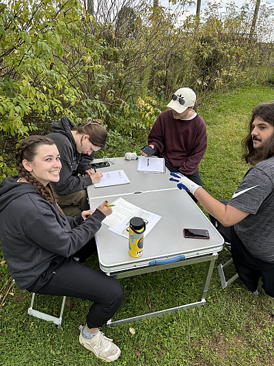 Students in the 2023 capstone class work on their signage plans in a welcoming and now well-veget...