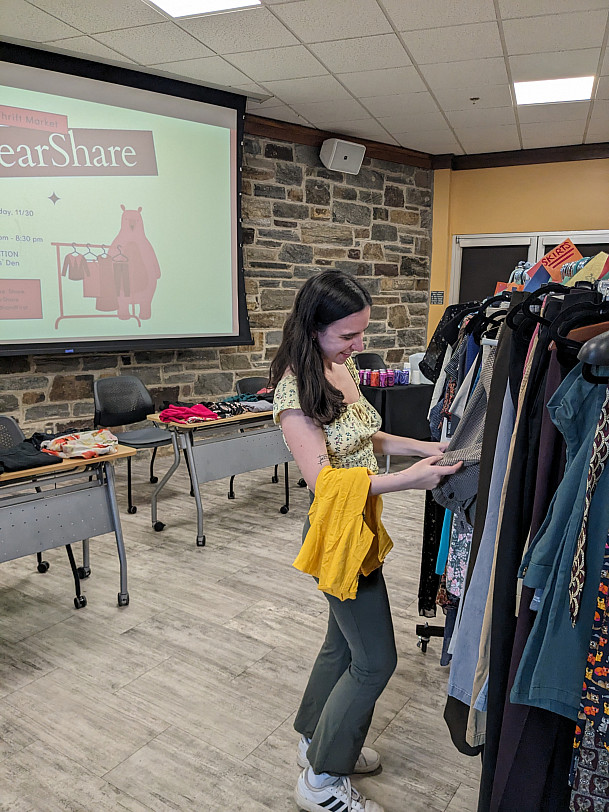 Student shopping for clothes at BearShare pop-up.