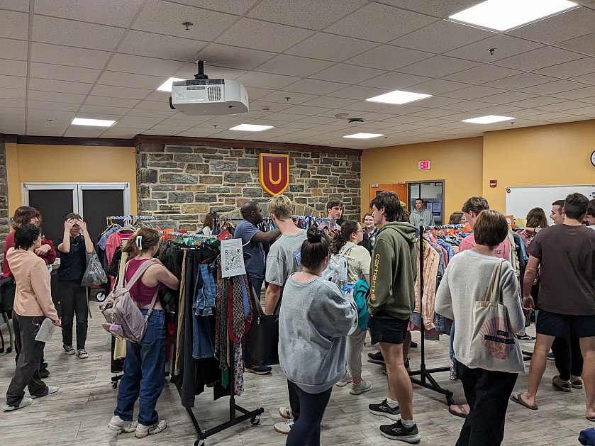 Students shopping for clothes at BearShare pop-up.