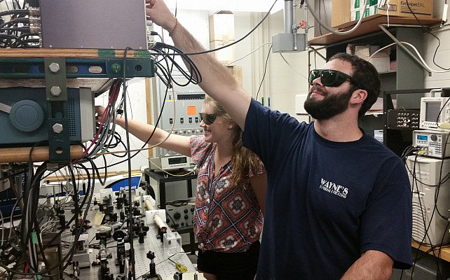 Veronica Sanford and Jacob Bigelow work in the ultracold atomic physics lab at Bryn Mawr College.