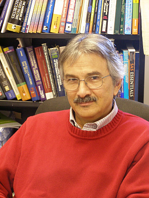 Photo of Andrew Economopoulos in a library