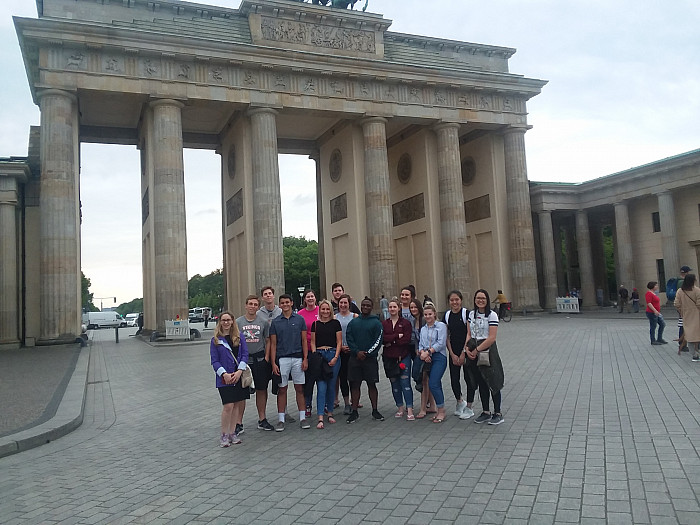 Ursinus students on the Economies in Transition study abroad trip stand in front of the Brandenburg Gate in Berlin.