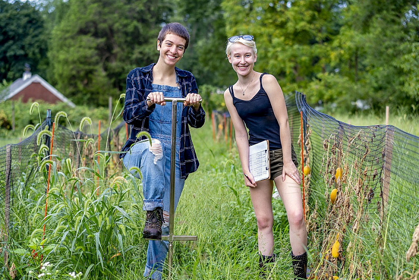 Ursinus students Madison Moses (left) and Jess Greenburg work on the Ursinus farm.