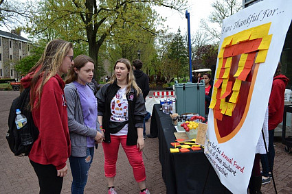 Students standing at a booth on Philanthropy Day