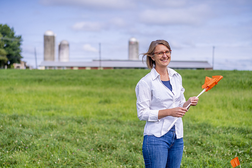 Dr. Denise Finney holding flags in a field at WERS