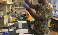 Rahsaan Sailes (FUTURE Student) assisting Avery Sicher with research project.